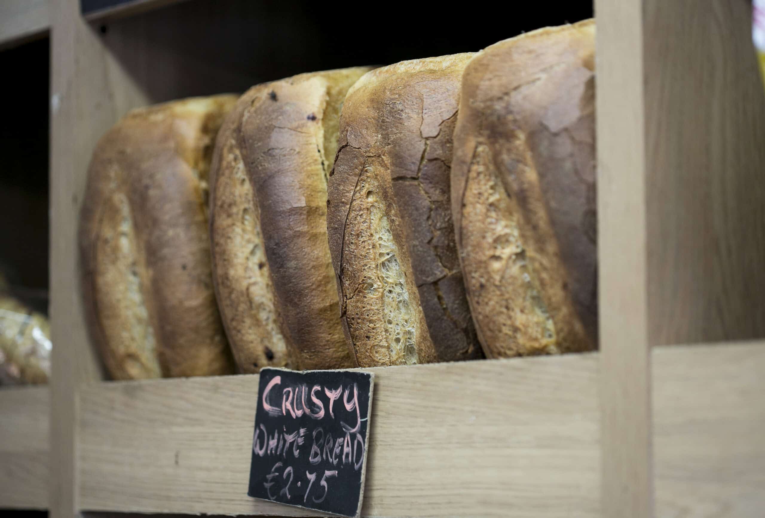 Freshly baked white bread loaves on display at The Auld Mill Bakery.