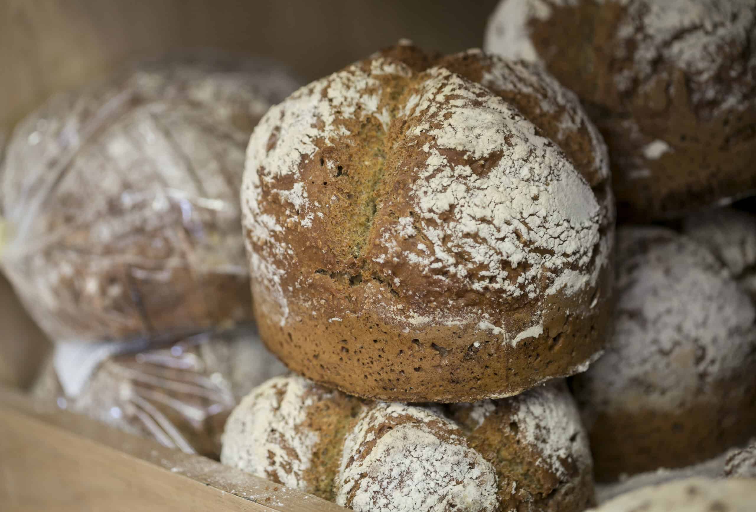 Irish brown bread loaves dusted with powdered sugar, freshly baked at The Auld Mill Bakery.