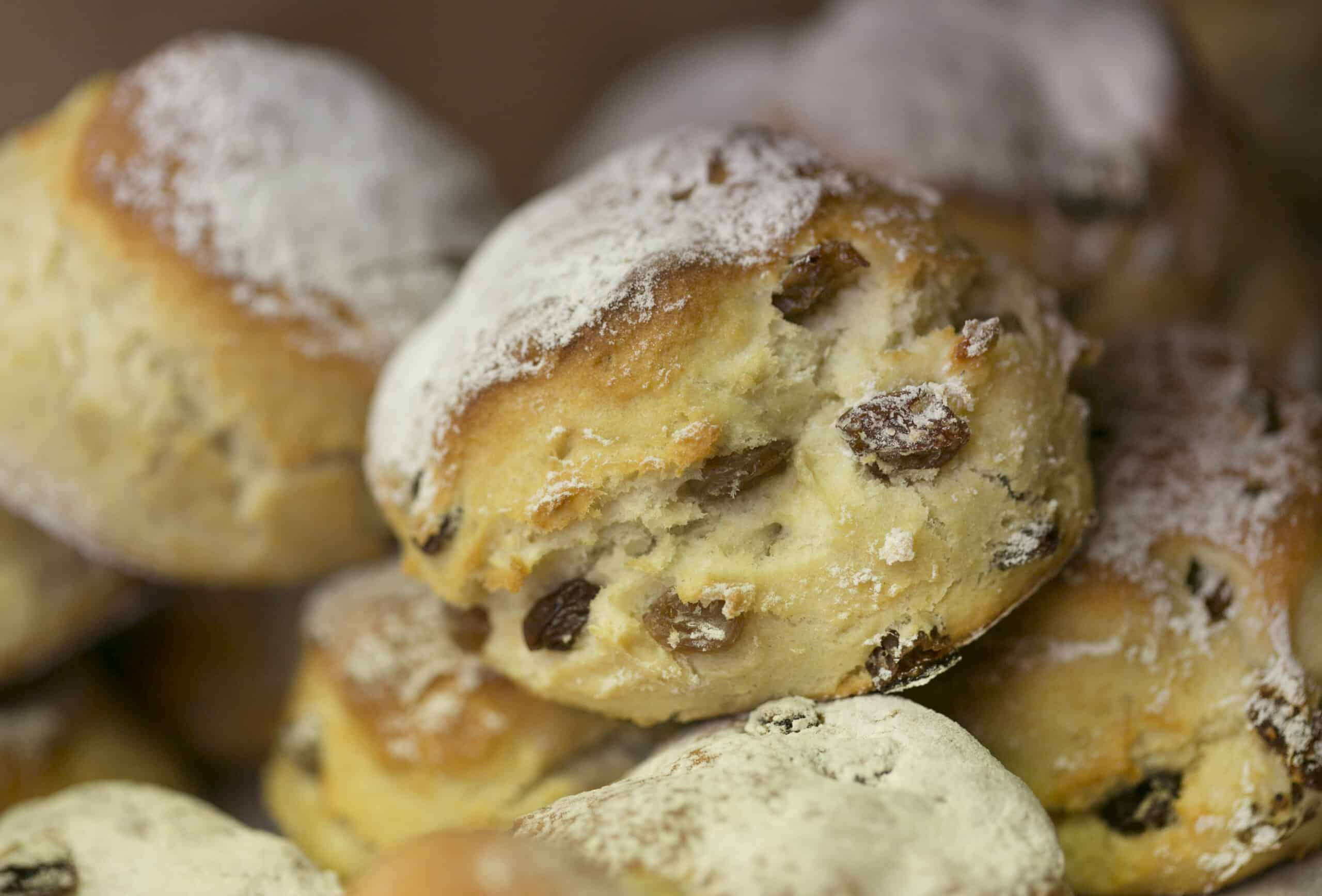 Freshly baked scones with raisins, dusted with powdered sugar, served at The Auld Mill Bakery.